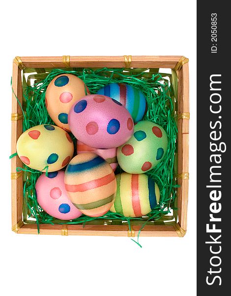 Easter eggs in a wooden basket. Isolated on a white background. Easter eggs in a wooden basket. Isolated on a white background.