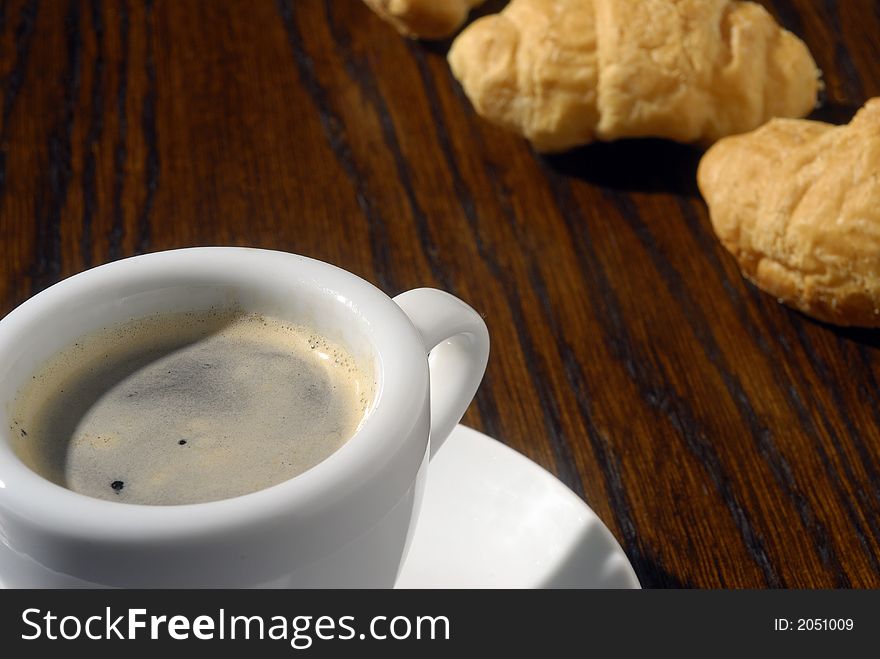 Black coffee and golden croissants. Black coffee and golden croissants