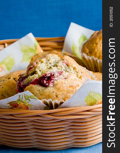 Couple of freshly baked cherry muffins in the woven basket. Couple of freshly baked cherry muffins in the woven basket