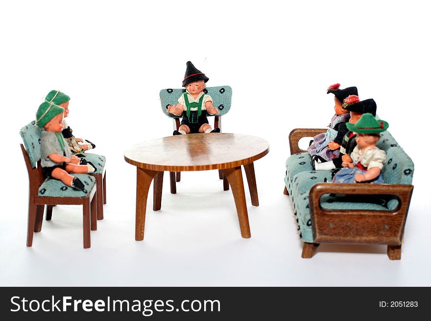 6 dolls in traditional European (I think they are Austrian but not sure) dresses sitting on chairs and couch round a table (old hand made furniture). 6 dolls in traditional European (I think they are Austrian but not sure) dresses sitting on chairs and couch round a table (old hand made furniture).