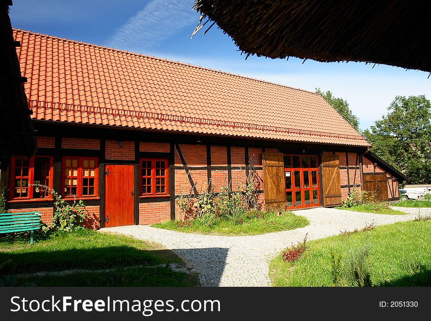 Traditional Polish checked houses, tile roof. Red brick. Traditional Polish checked houses, tile roof. Red brick.