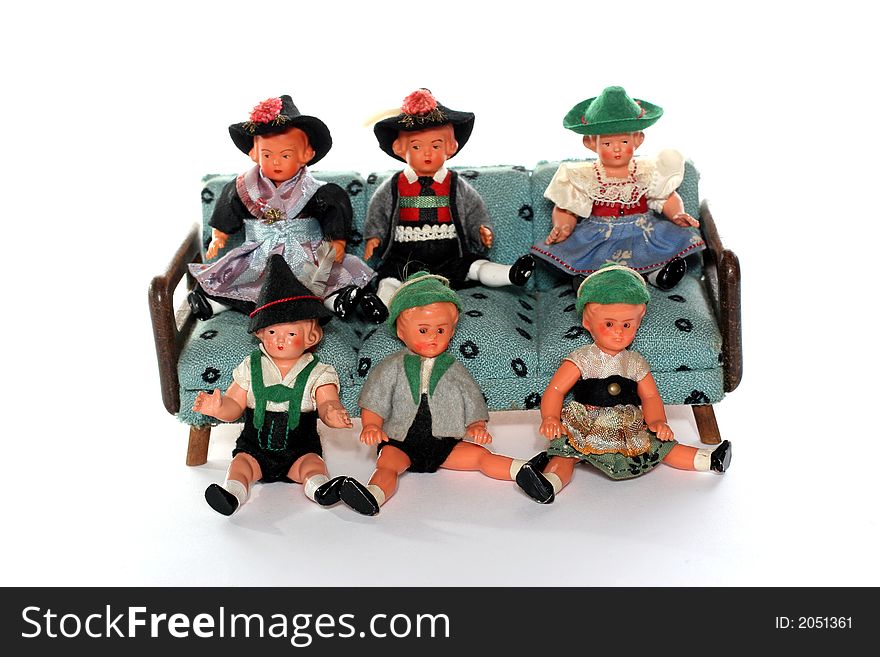 6 dolls in traditional European (I think they are Austrian but not sure) dresses sitting on and infront of a couch (old hand made furniture). 6 dolls in traditional European (I think they are Austrian but not sure) dresses sitting on and infront of a couch (old hand made furniture).