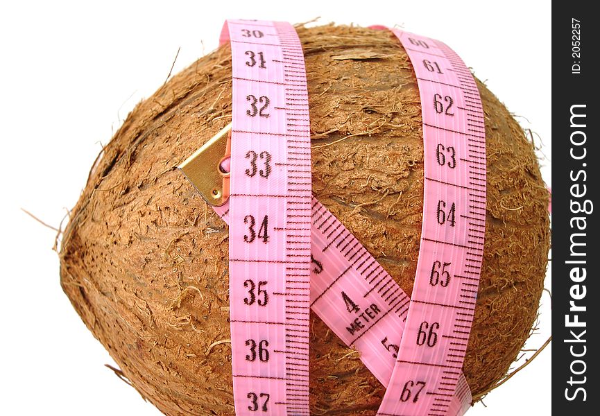 Coconut with pink tape measure over white background (concept of health, diet)