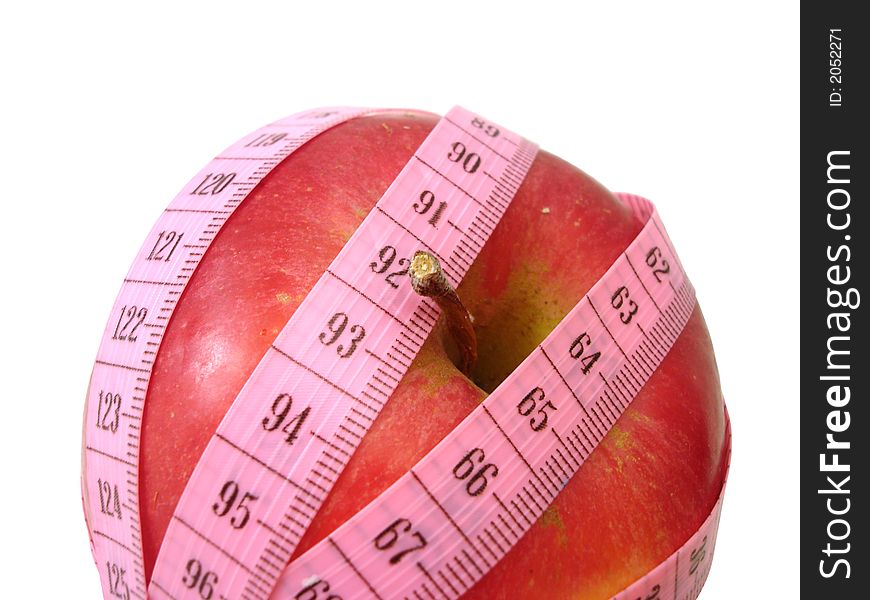 Apple with pink tape measure over white background (concept of health, diet)