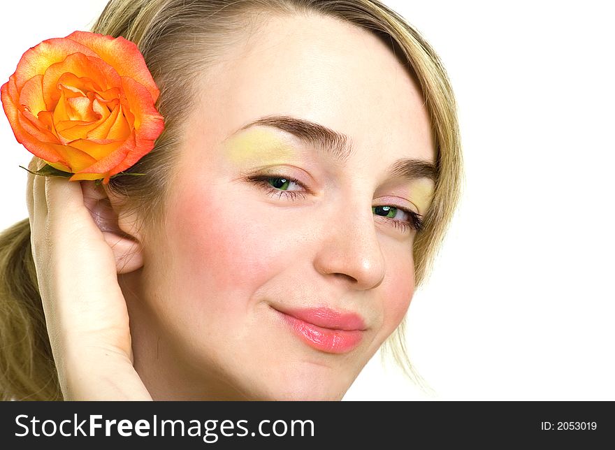 Portrait of beautiful blonde girl with rose in her hair