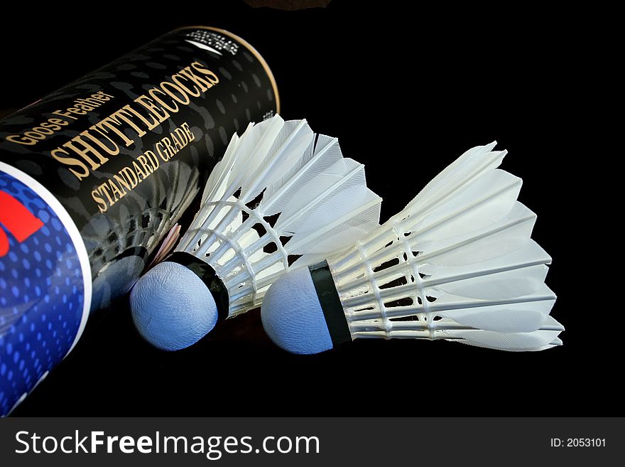 Two shuttlecocks and tube isolated on a black background