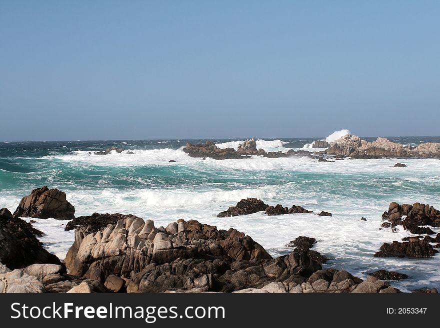 Waves crashing into rocks on Monterey Bay