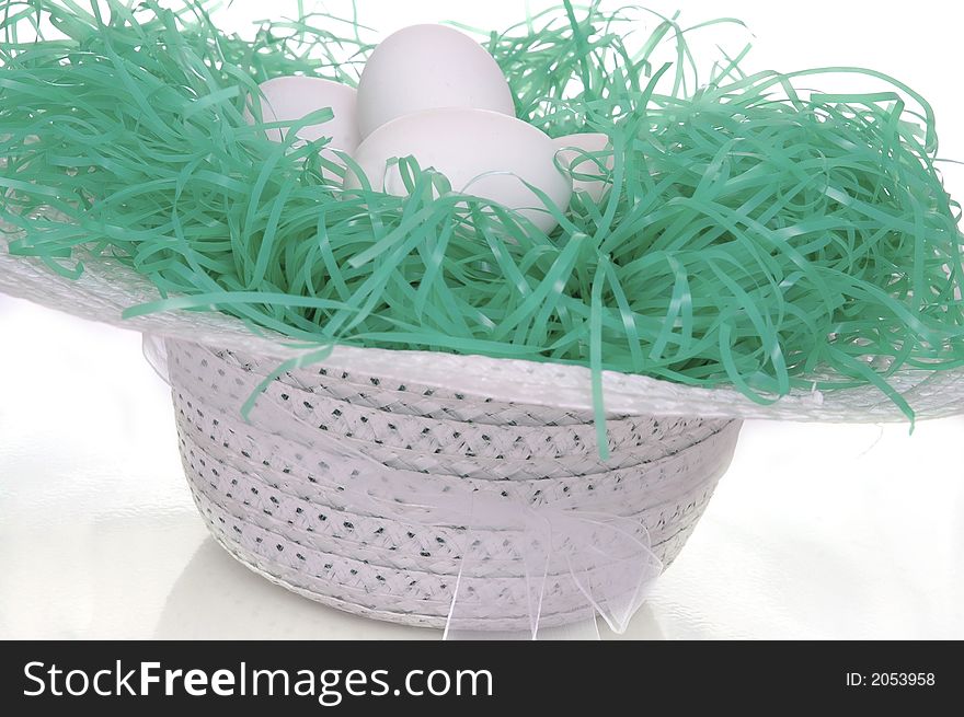 A spring hat filled with easter eggs. White background. A spring hat filled with easter eggs. White background.