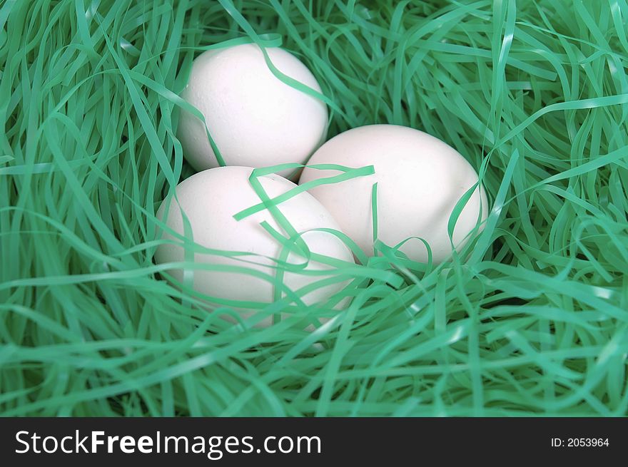 Easter eggs nestled in green Easter grass.