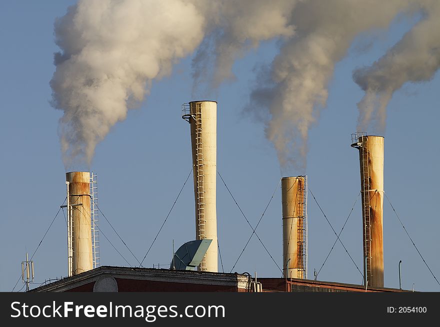 Factory chimney throwing out puff of smoke and vapour. Factory chimney throwing out puff of smoke and vapour