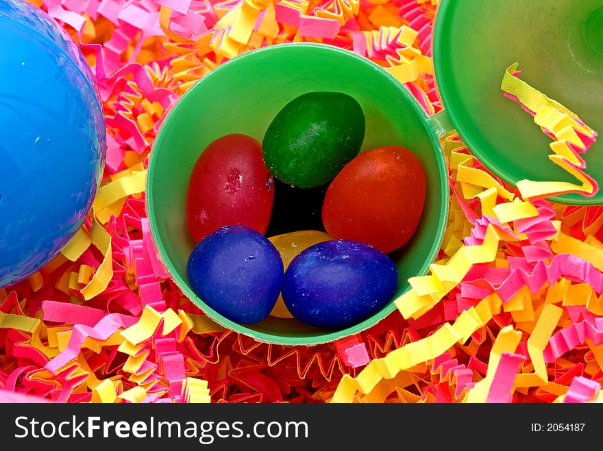 Colorful jelly beans in a green plastic egg