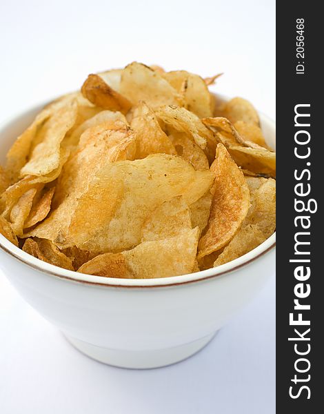 Crispy Kettle type potato chips in a country bowl. Crispy Kettle type potato chips in a country bowl