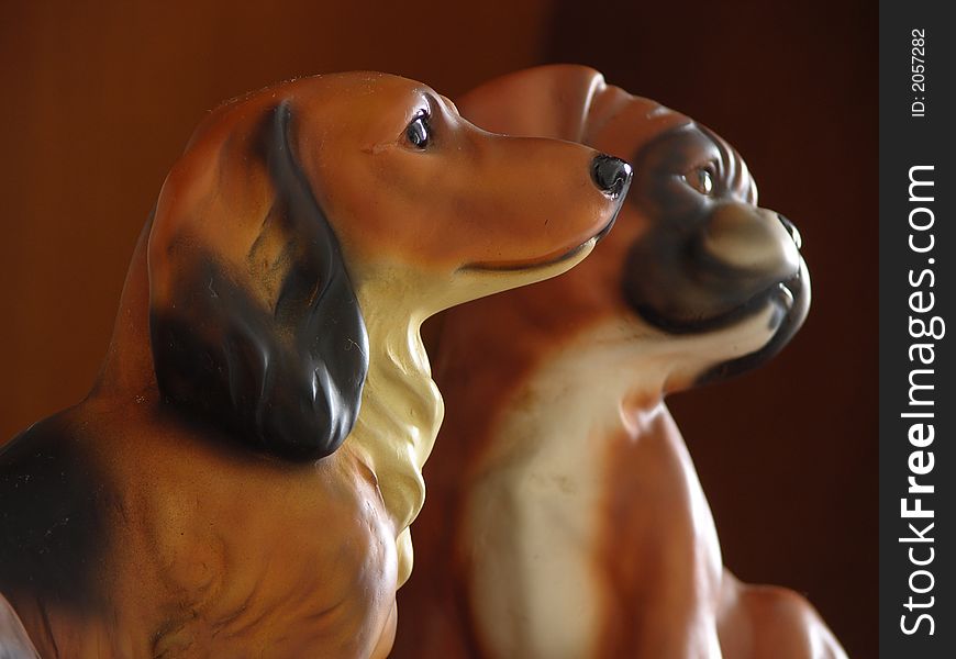 2 Dog Figurines Staring At The Bright Window. 2 Dog Figurines Staring At The Bright Window