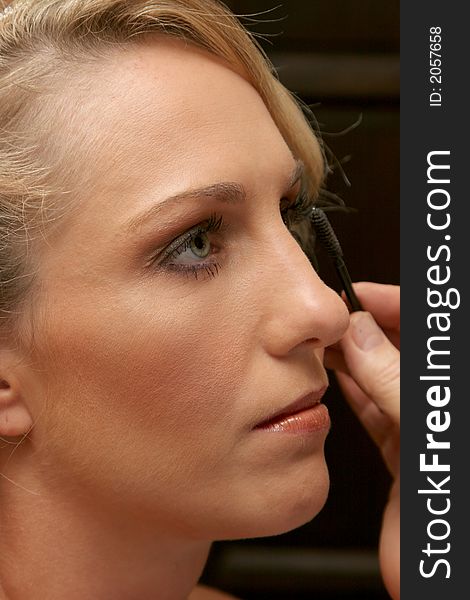 A blonde woman having her makeup done. A blonde woman having her makeup done