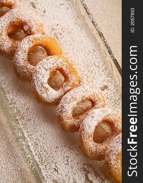 Oval doughnuts with icing sugar put together