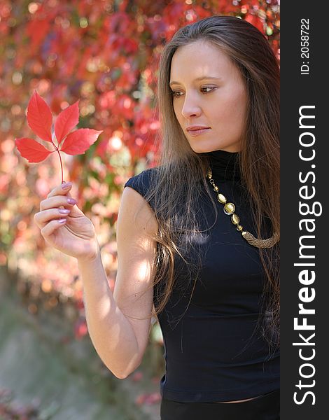 Girl holding a red leaf. Girl holding a red leaf