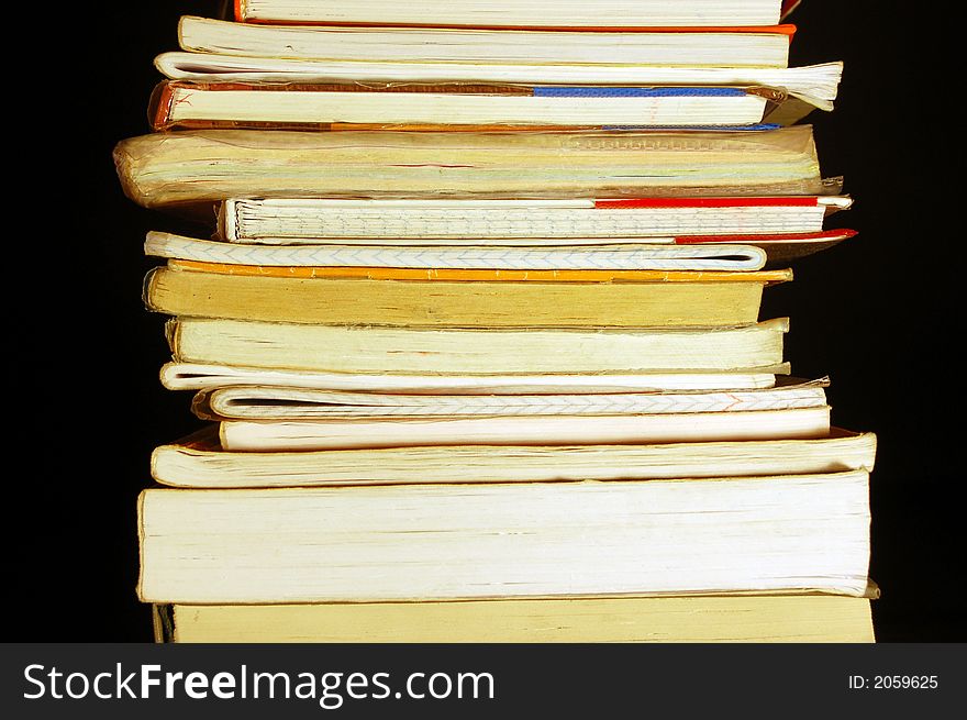 Books pile isolated on black