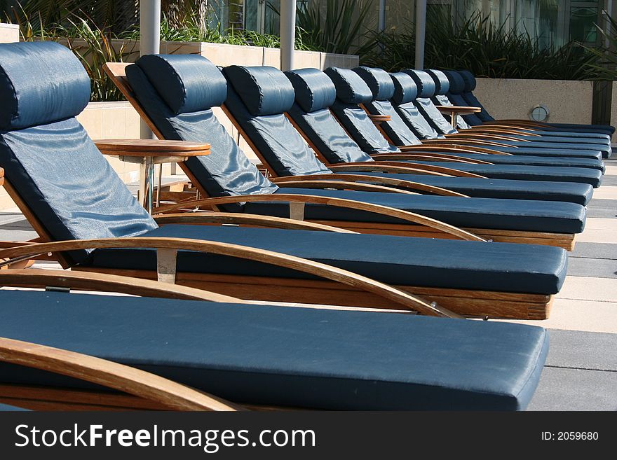 A group of poolside lounge chairs.