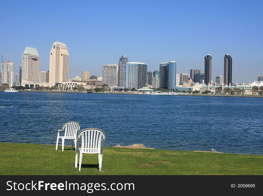 A pair of chairs on the Coronado shore. Downtown San Diego in the background. A pair of chairs on the Coronado shore. Downtown San Diego in the background.