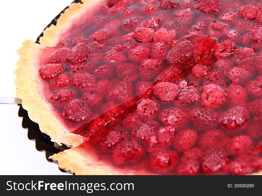 Raspberry Tart in a tart pan, a portion cut out