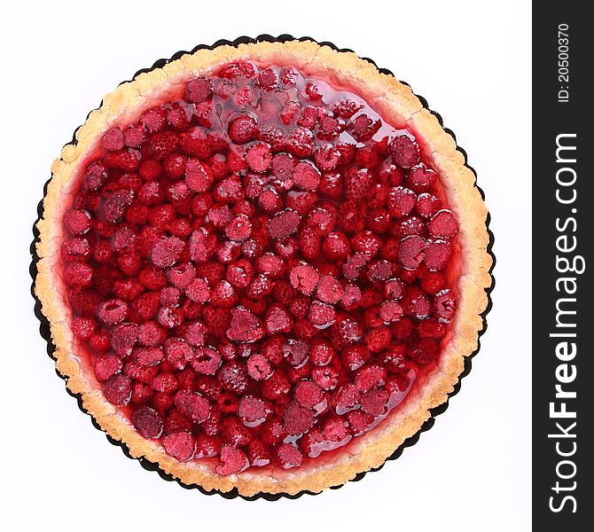 Raspberry Tart in a tart pan on a white background