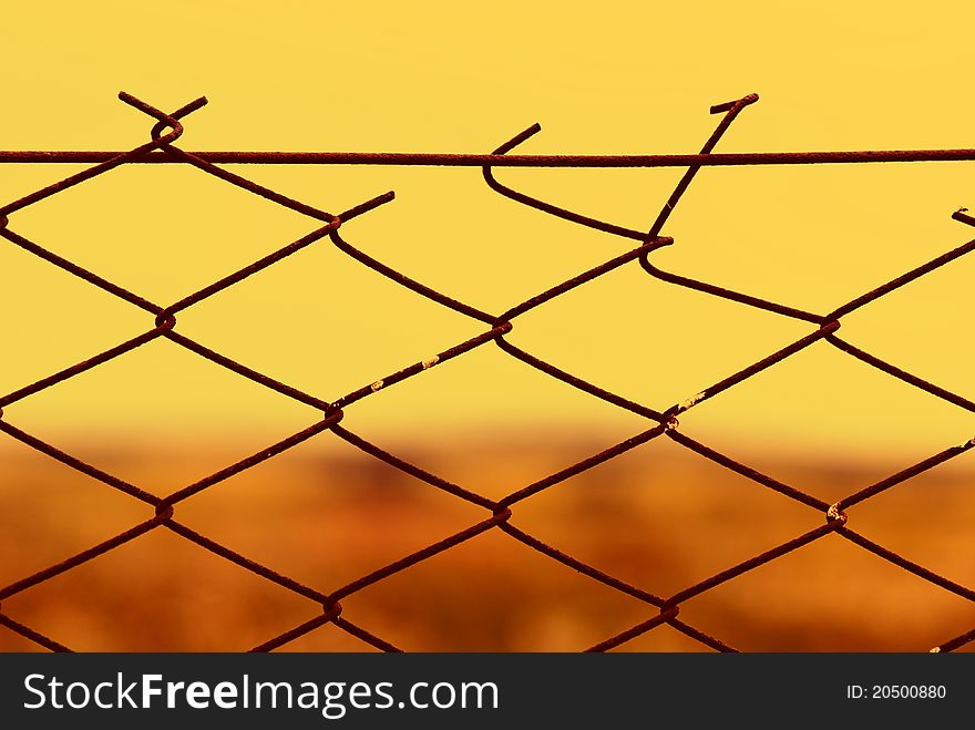 Metallic fence background tint in warm colors. Metallic fence background tint in warm colors