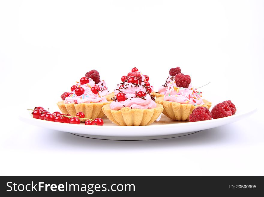 Tartlets with whipped cream, fruits and sprinkles