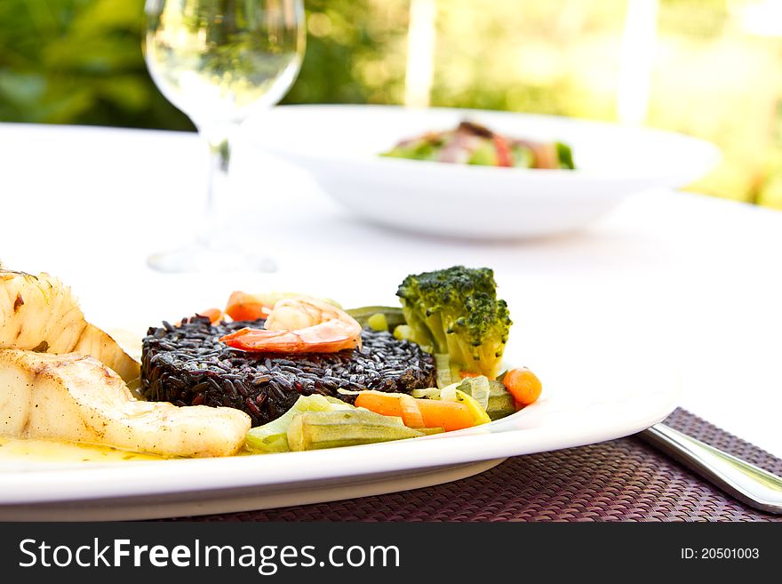 Fish with black rice, vegetables and prawn. Fish with black rice, vegetables and prawn