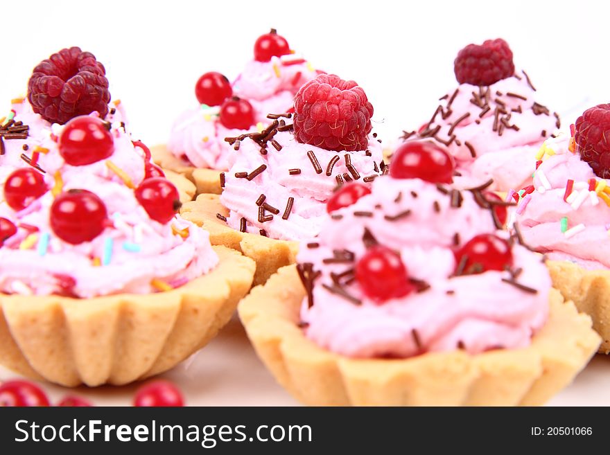 Tartlets with whipped cream, fruits and sprinkles