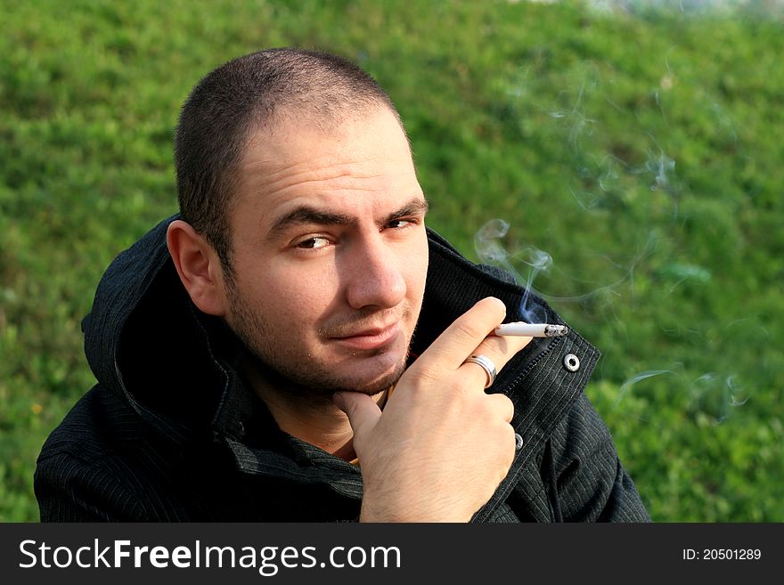 Caucasian man holding a cigar