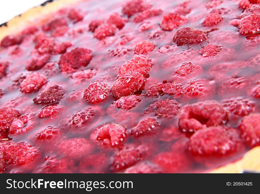 Raspberry Tart in a tart pan on a white background