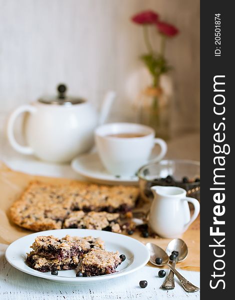 Breakfast with homemade blueberry pie, fresh blueberries and white cup of tea. Breakfast with homemade blueberry pie, fresh blueberries and white cup of tea