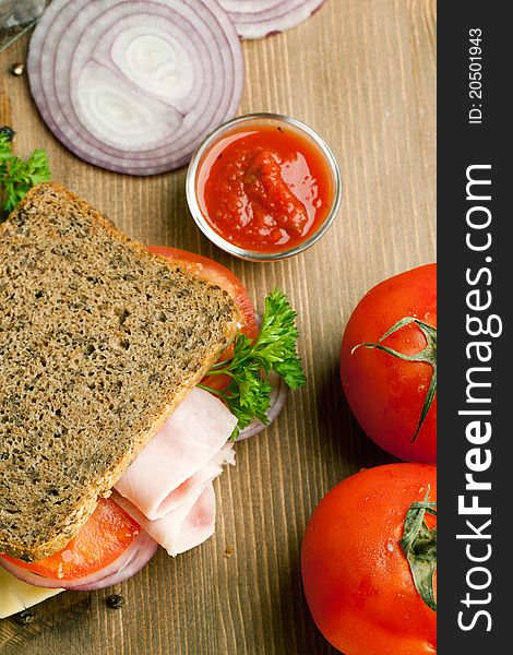 Fresh sandwich with ham, onion and tomato