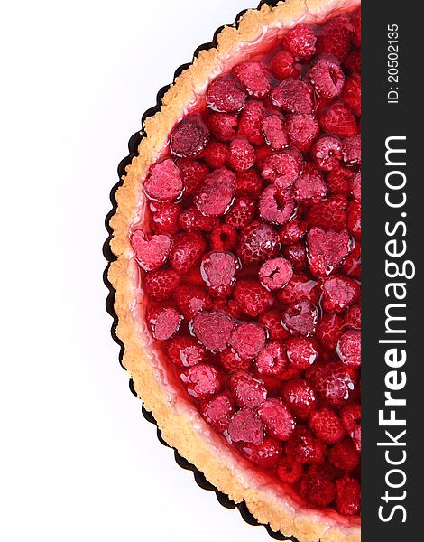 Raspberry Tart in a tart pan on a white background. Raspberry Tart in a tart pan on a white background