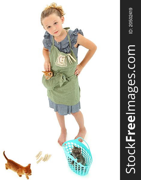 Adorable Girl Child in Apron playing house homemaker with kittens. Retro dress and apron over white background. Adorable Girl Child in Apron playing house homemaker with kittens. Retro dress and apron over white background.