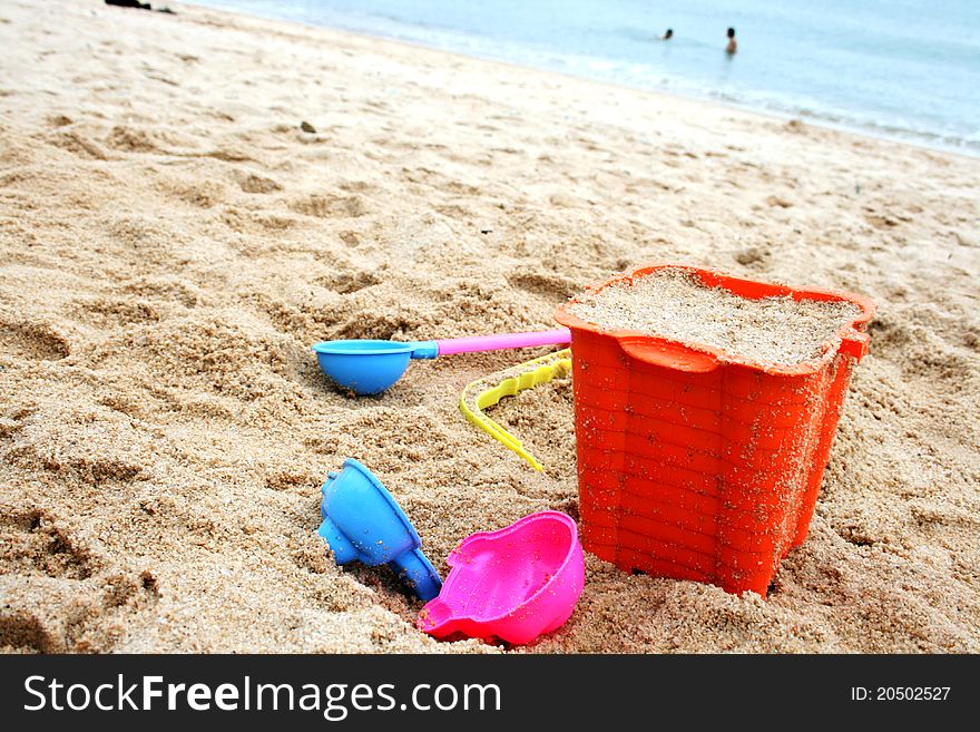 Some children's beach toys on sand