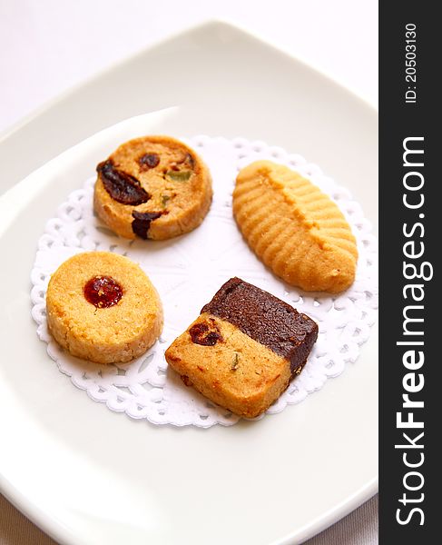 Various cookies on white dish