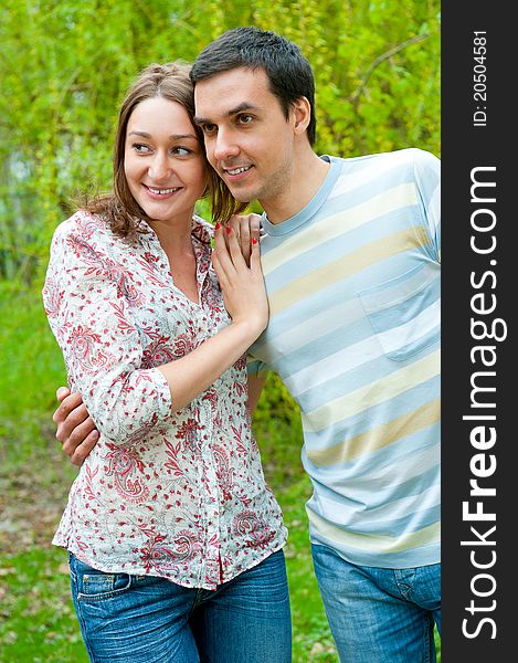 Beautiful young couple portrait in a park