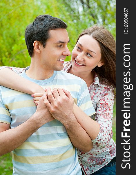 Beautiful young couple portrait in a park