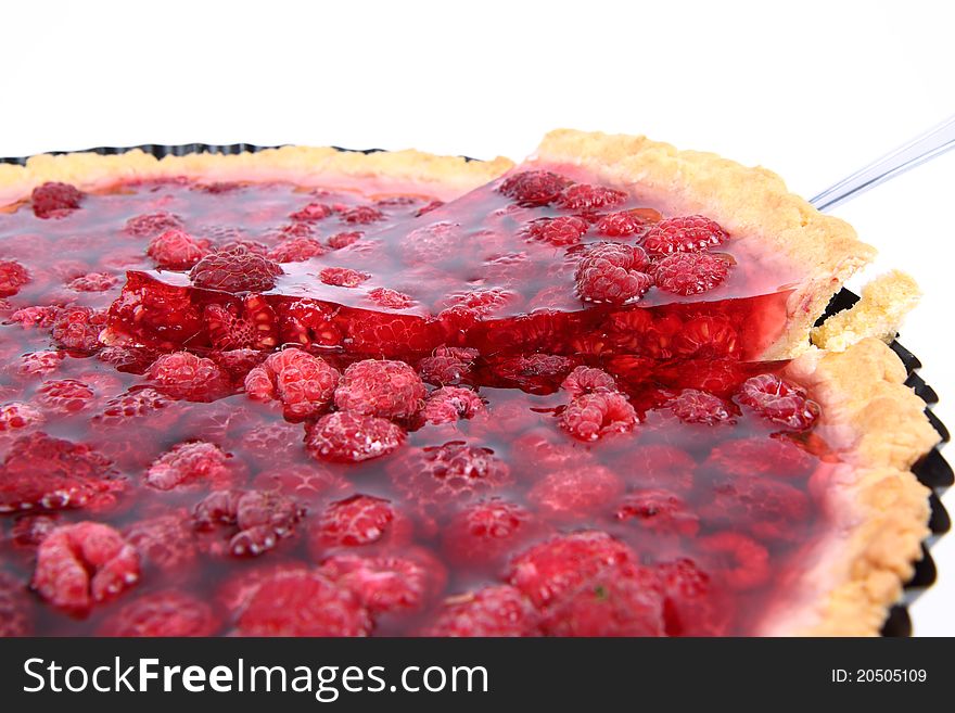 Raspberry Tart in a tart pan, a portion cut out