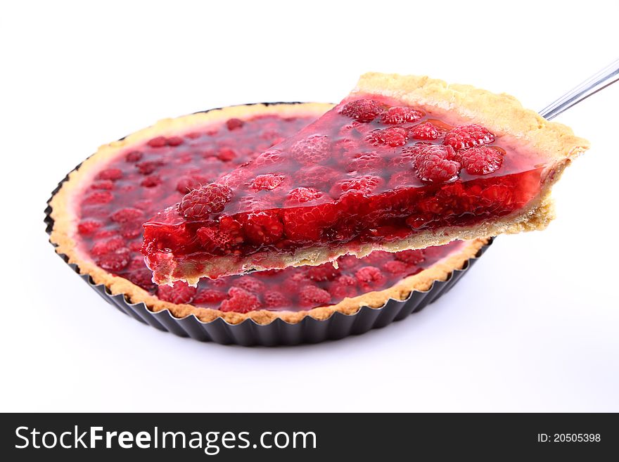 Raspberry Tart in a tart pan, a portion cut out