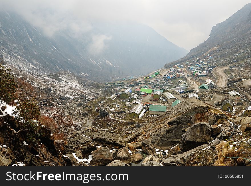 Multi colored scattered houses in Himalayan valleys in Sikkim, India. Multi colored scattered houses in Himalayan valleys in Sikkim, India.