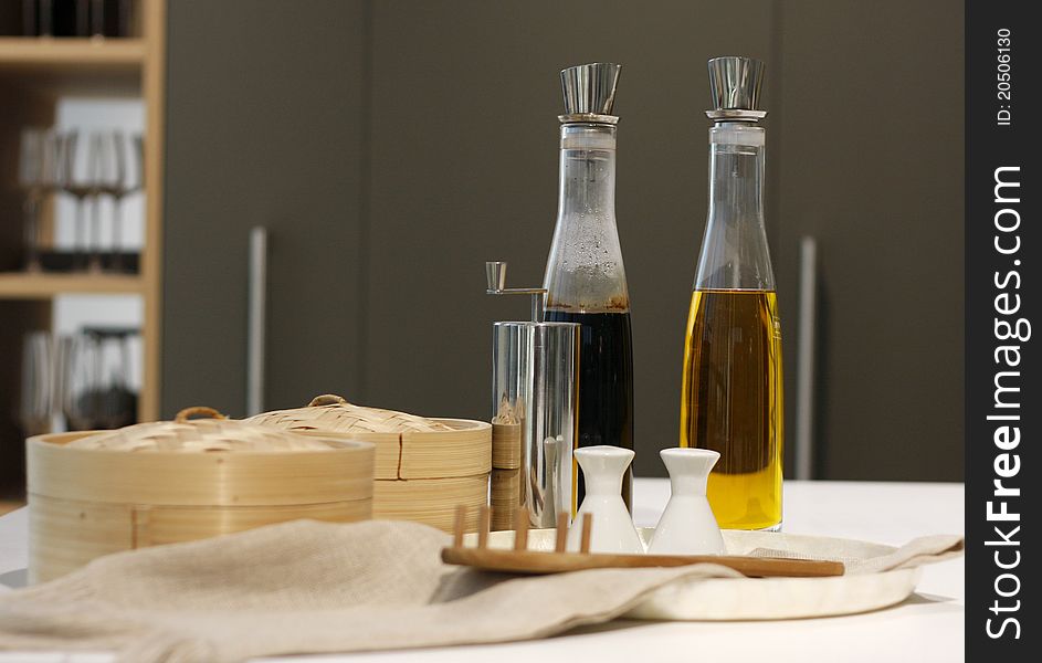 Bottles of the olive oil and balsamic vinegar, boxes, pepper and salt pot.