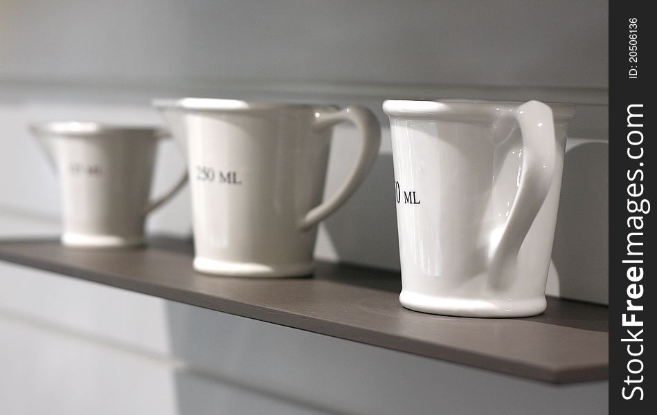 Measuring cups on the shelf.