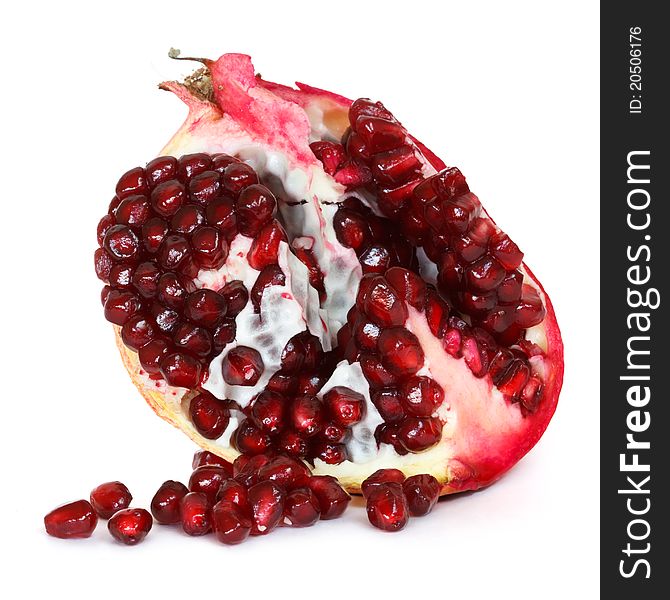 Pomegranate with loose seeds over white background