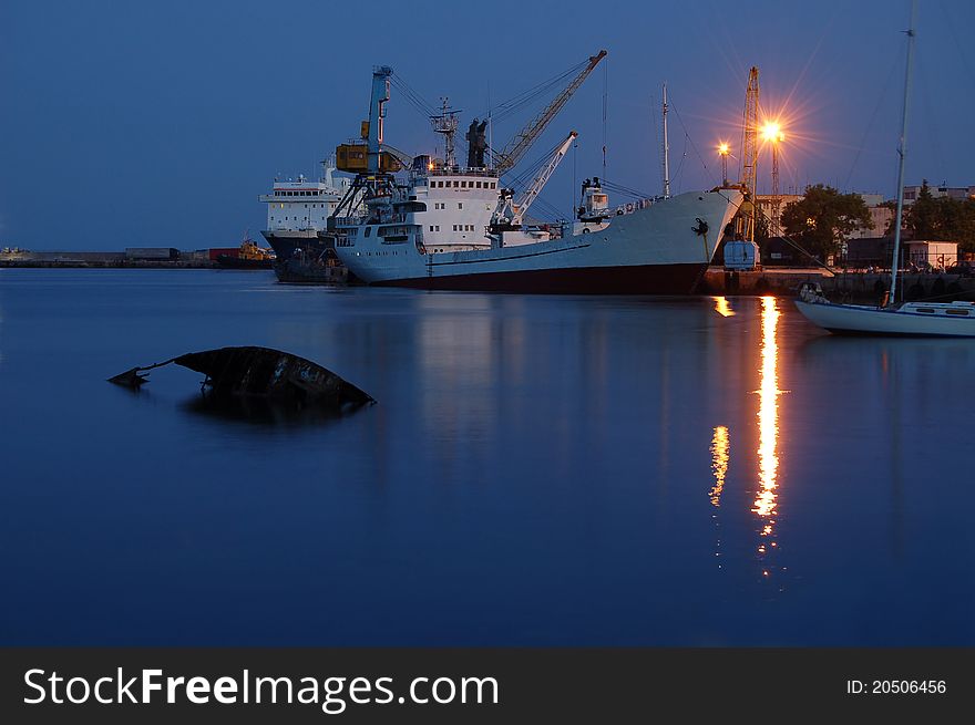 Night sea port with transport.