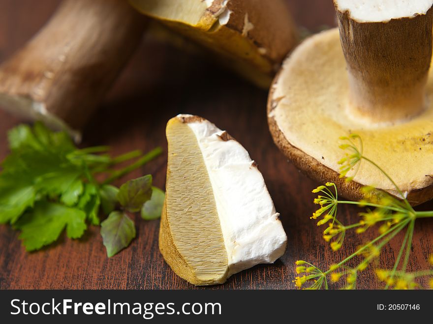 Boletus mushroom whole and cut on wooden background