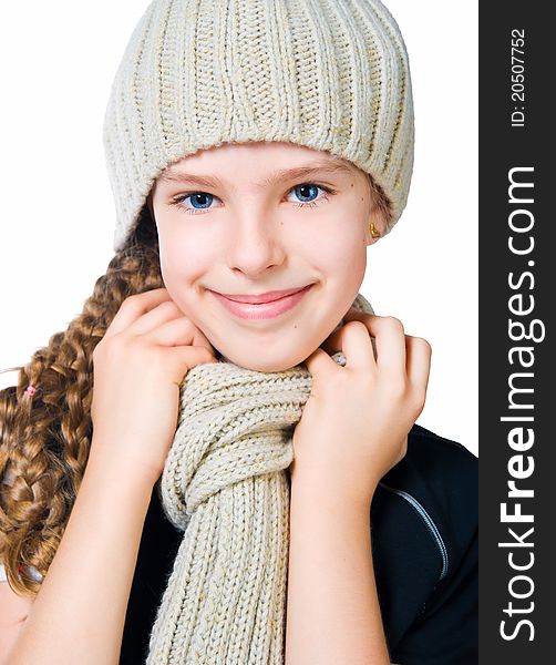 Beautiful little girl in cap and scarf  isolated on white