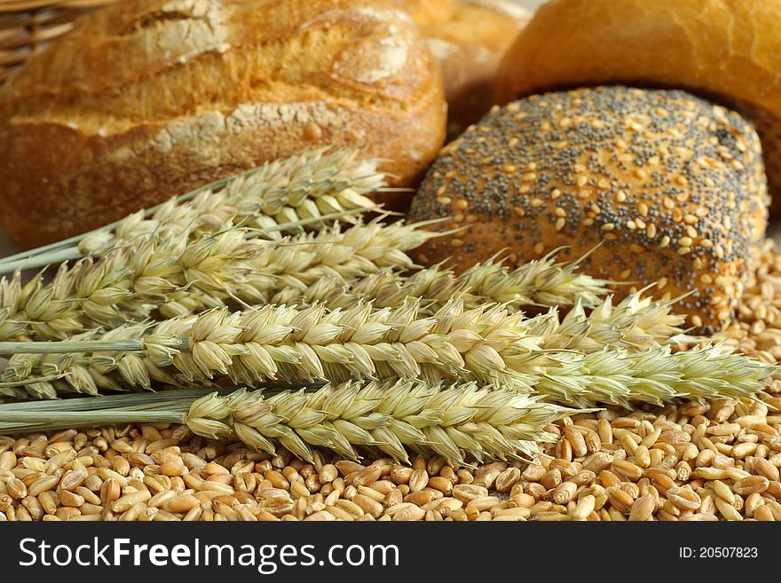 Still-life with wheat and rolls