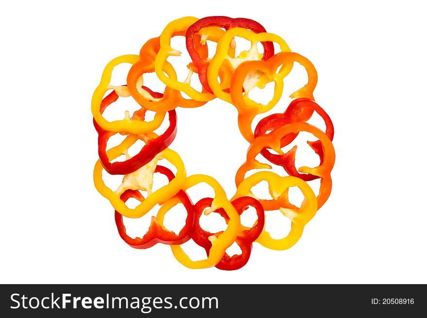 Bell-peppers slices organized in a circle isolated on white